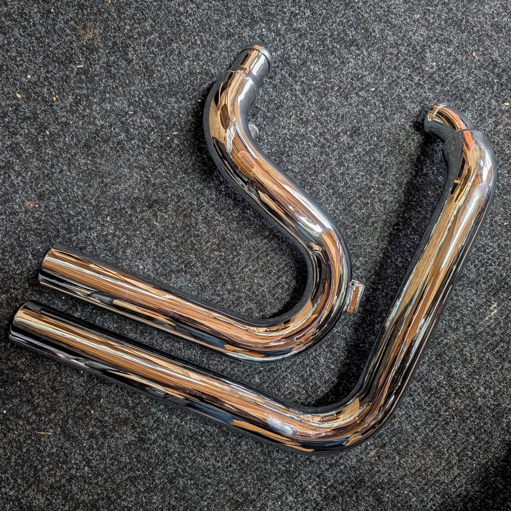 Sleek Chrome Exhaust Pipes, Harley Davidson Evolution Engine.